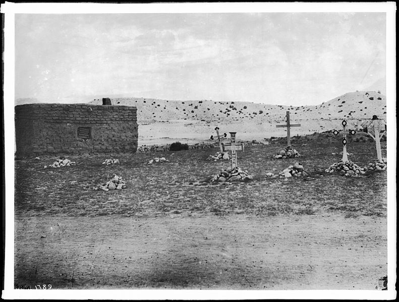 Photograph of a grouping of five penitente crosses stuck in small piles of stones, San Rafael, New Mexico, ca.1900. Via Wikimedia Commons.