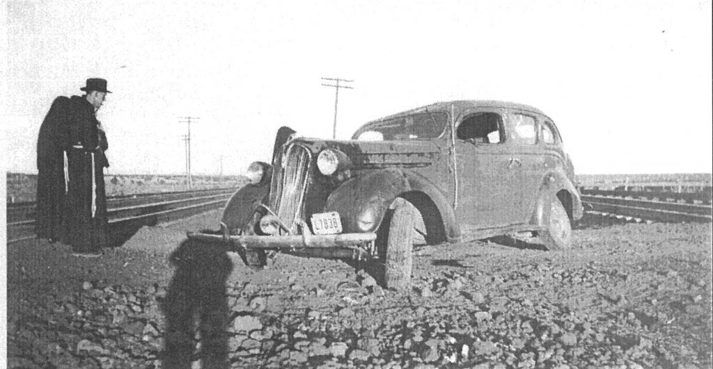 Fr. Emanuel and Sisters viewing an automobile that tried to beat the train while crossing the tracks.