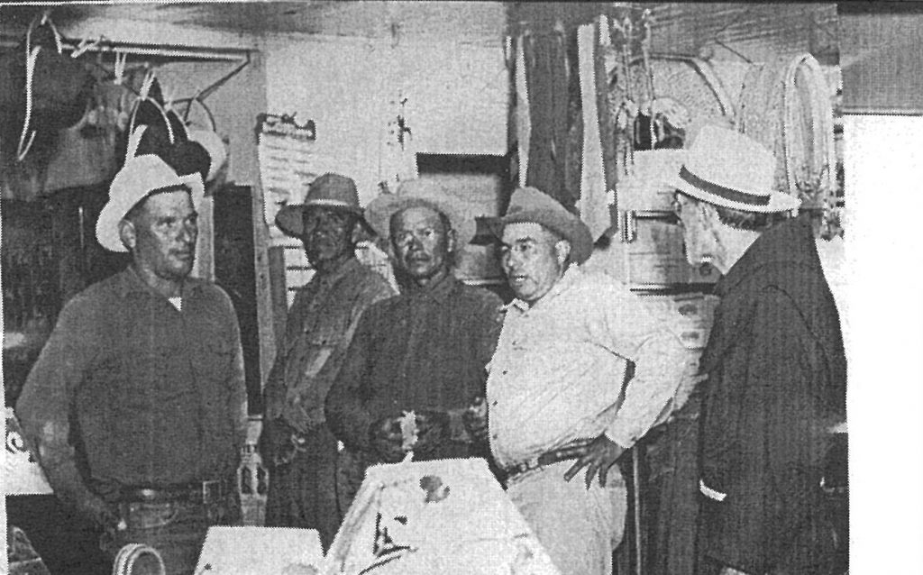 Fr. Emanuel Trockur, right, at the old trading post. From left, Roman Hubbell, John Collier, John Baldwin and Hoskie Cronemeyer.